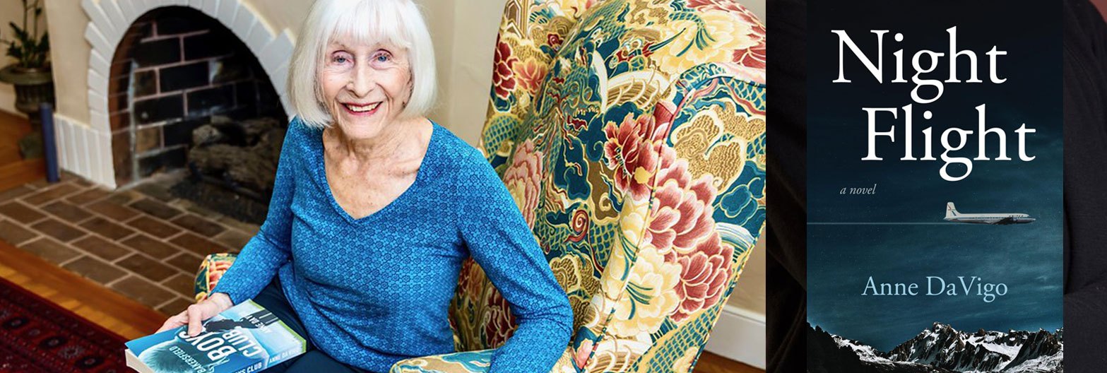 Author of Night Flight Anne da Vigo Author in a chair holding a book