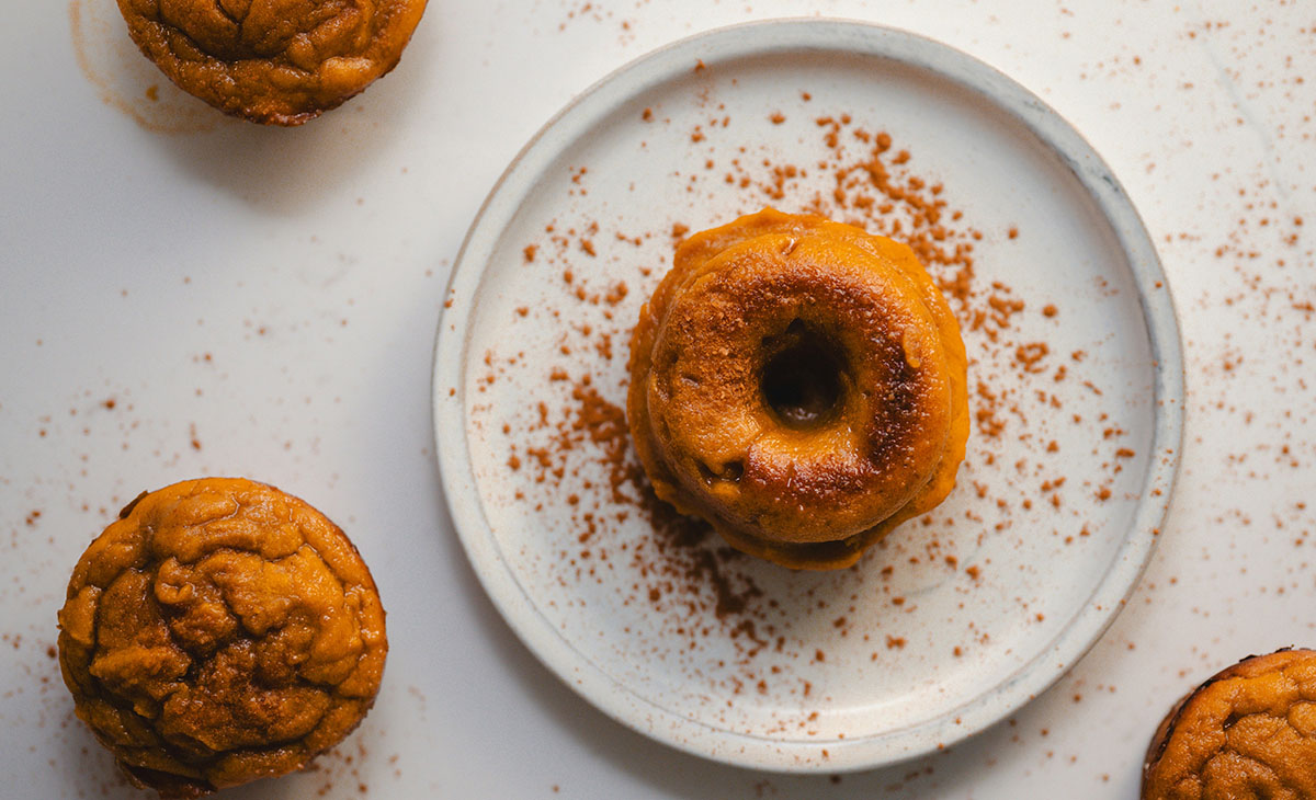 A donut and some bakery goods appear against a white background.