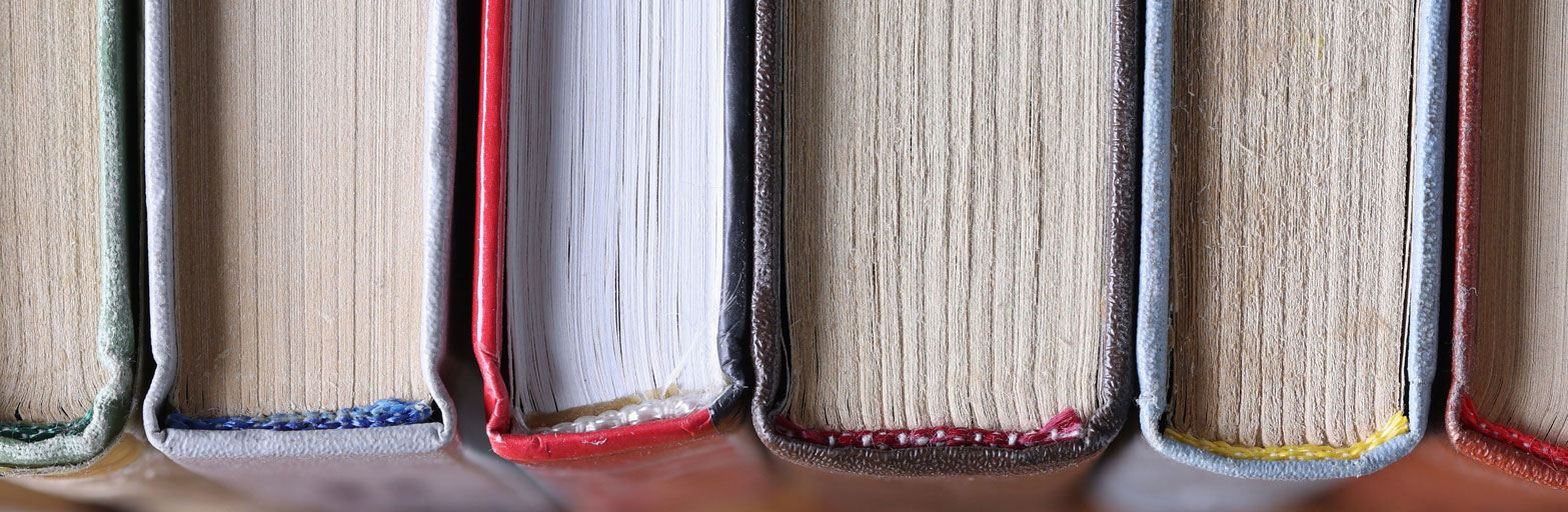 a close up top view of books and spines showing the pages and the stiching