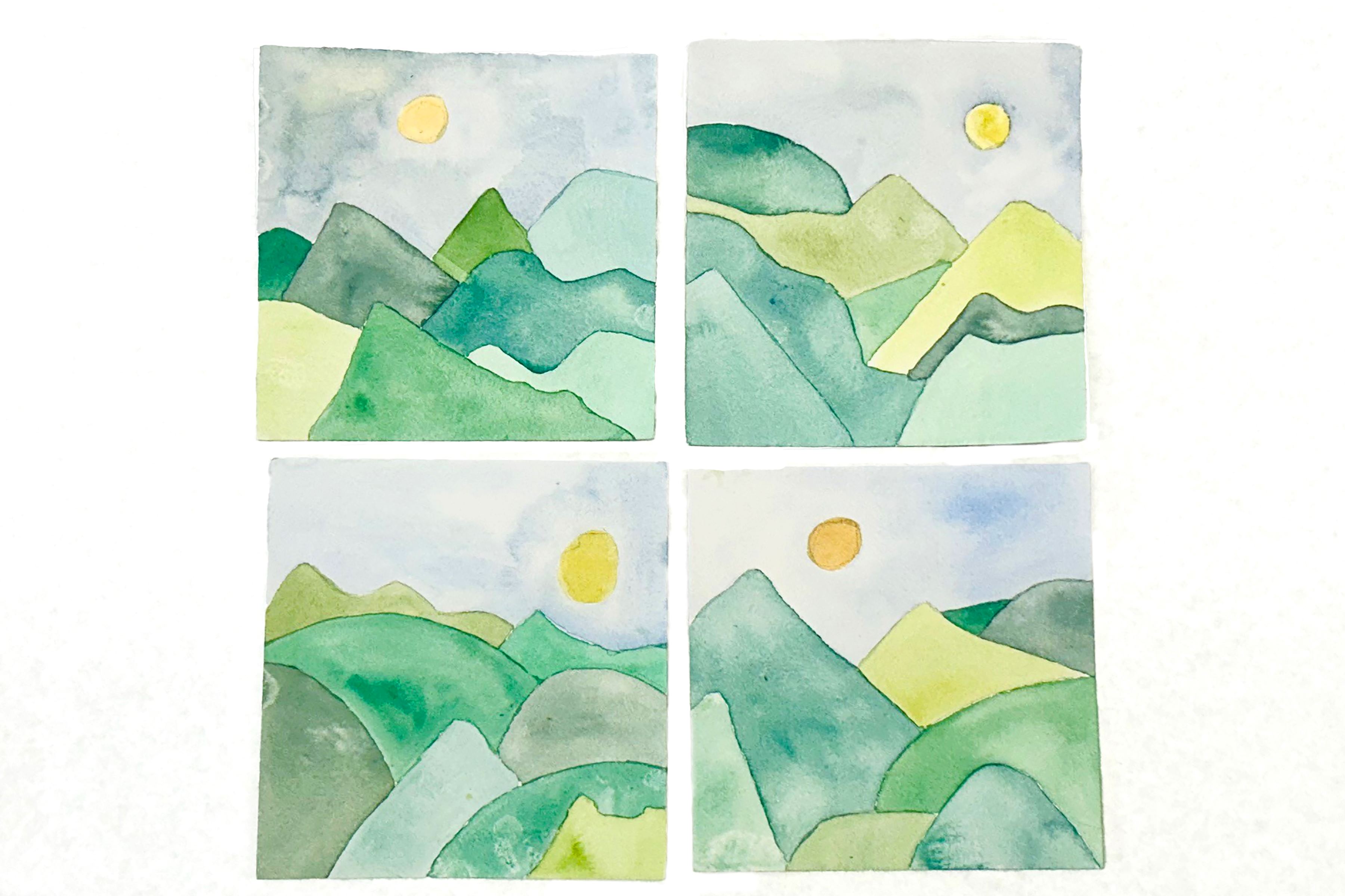 Set of four square watercolor landscapes of mountains against a sun in the sky each using the same palette of yellows, greens, and blues.
