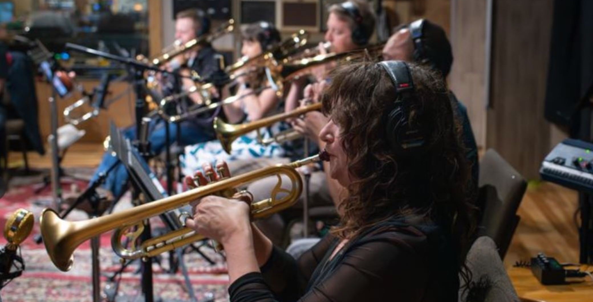 Gora Gora Orkestar sitting down playing their instruments.