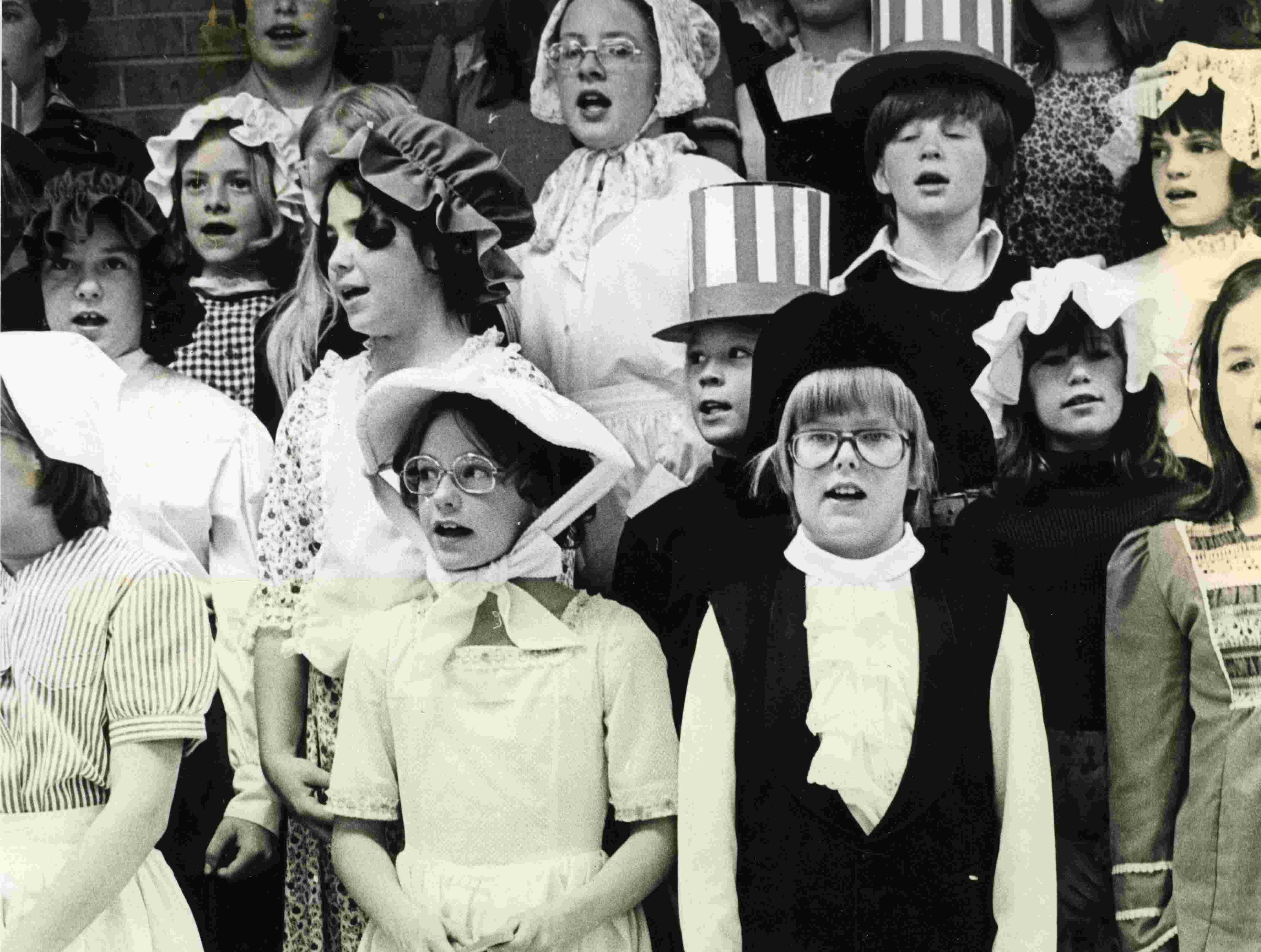 A historic photo of a group of children dressed for a celebration