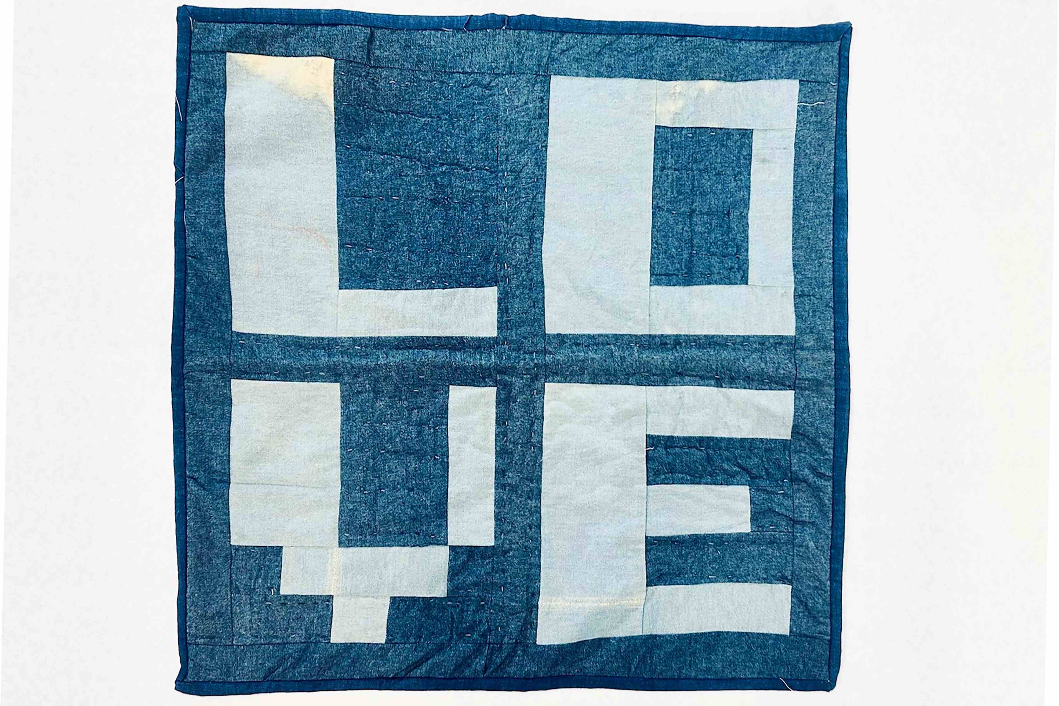 A blue and white quilt with the word LOVE