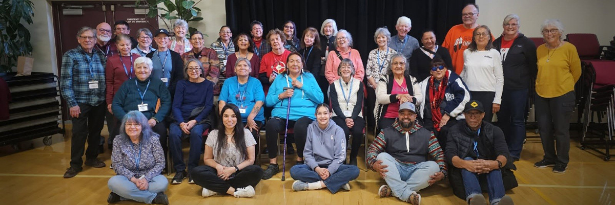 Thirty-six people, all participants or staff involved in the 2025 Longmont Senior Services Elder Exchange with the Wind River Reservation, pose for a photo in the Senior Center gym.