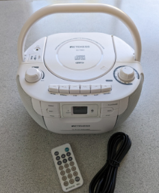 white CD player and black power cord