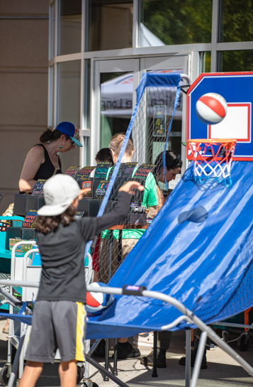person playing mini basketball outside the library