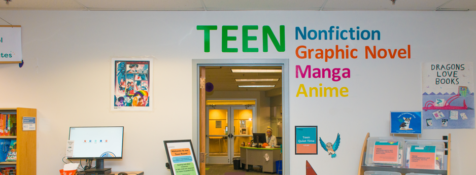 Entrance of the Teen Room at Longmont Public Library with a painting of a gnome and fiction, non fiction words at doorway.