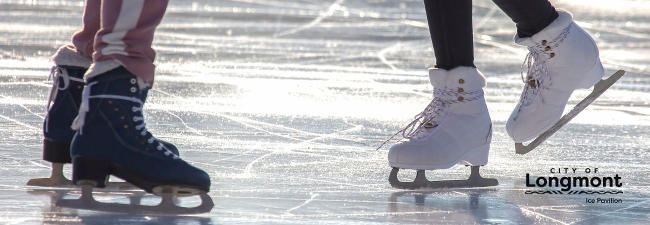 sheet of ice with two people skating showing ankles and skates only