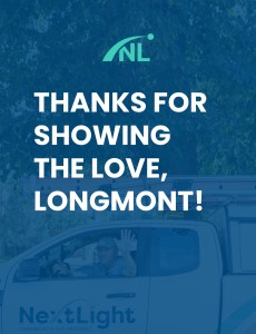 A NextLight logo over the words "Thanks for Showing the Love, Longmont!" The image and words are superimposed over a blue-filtered picture of a driver in a NextLight vehicle