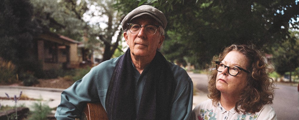 Mollie O'Brien and Rich Moore photographed together in a neighborhood.