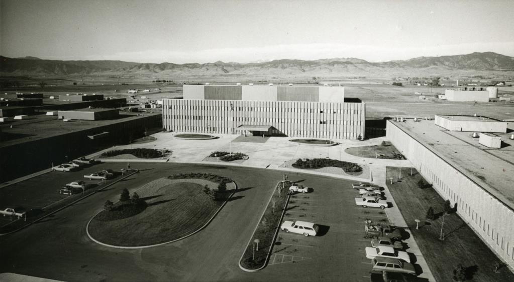 Black and white image of IBM’s Main plaza is shown in this aerial view of the front of the Administration building in the background, a parking lot with an oval grassy area and another building to the right at IBM, circa 1969. (Photo by Leigh Wiener / Longmont Times-Call)