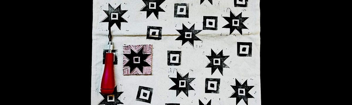Snapshot of a tote with black block printing on it.