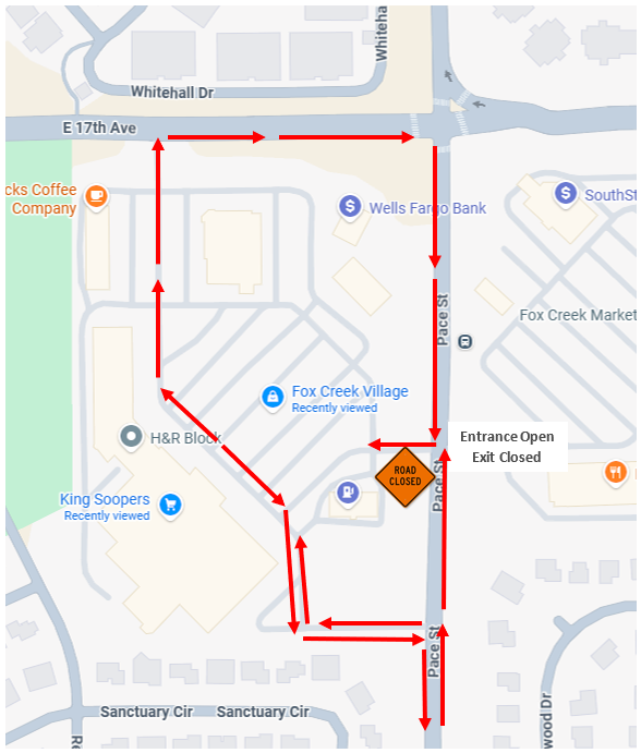 Map showing a temporary traffic detour for a closure at the north driveway connection to Pace Street serving the Fox Creek Village shopping center. The entrance from Pace Street remains open, but the exit is closed. Drivers leaving the shopping center are directed west through the parking lot, then north to East 17th Avenue, east along East 17th Avenue to Pace Street, and south on Pace Street to continue their route. Red arrows mark the detour, and a "Road Closed" sign is shown at the closed exit on Pace Street.