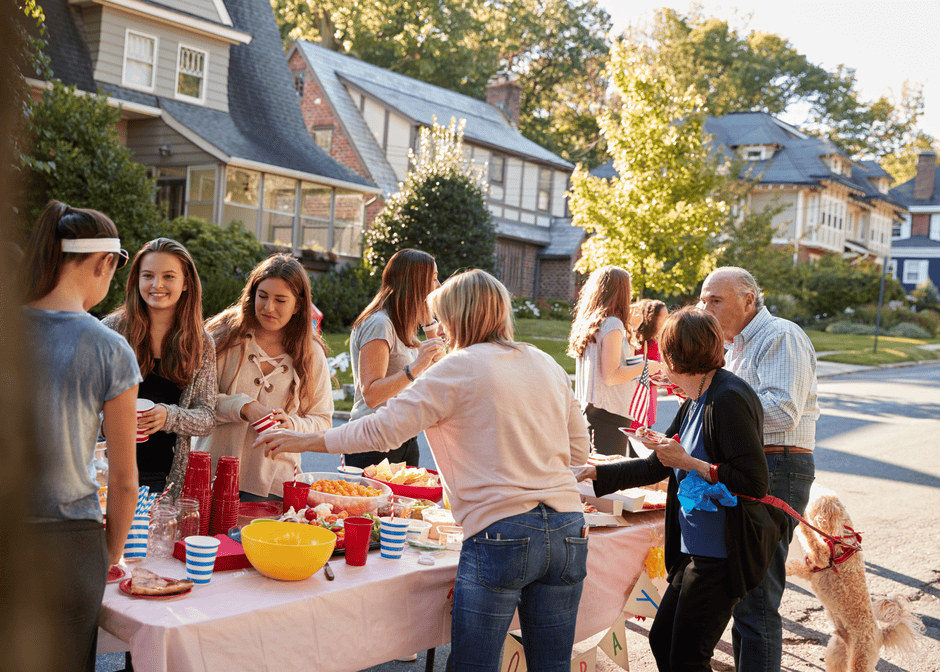 Neighbors sharing food around a table