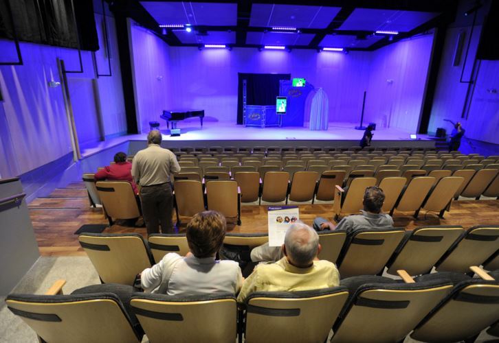 View of auditorium with some audience in foreground