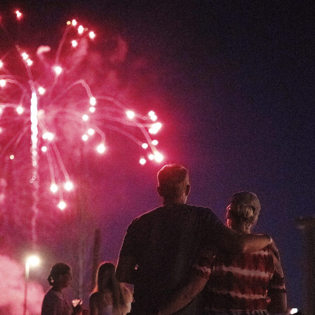 A couple embracing watching fireworks