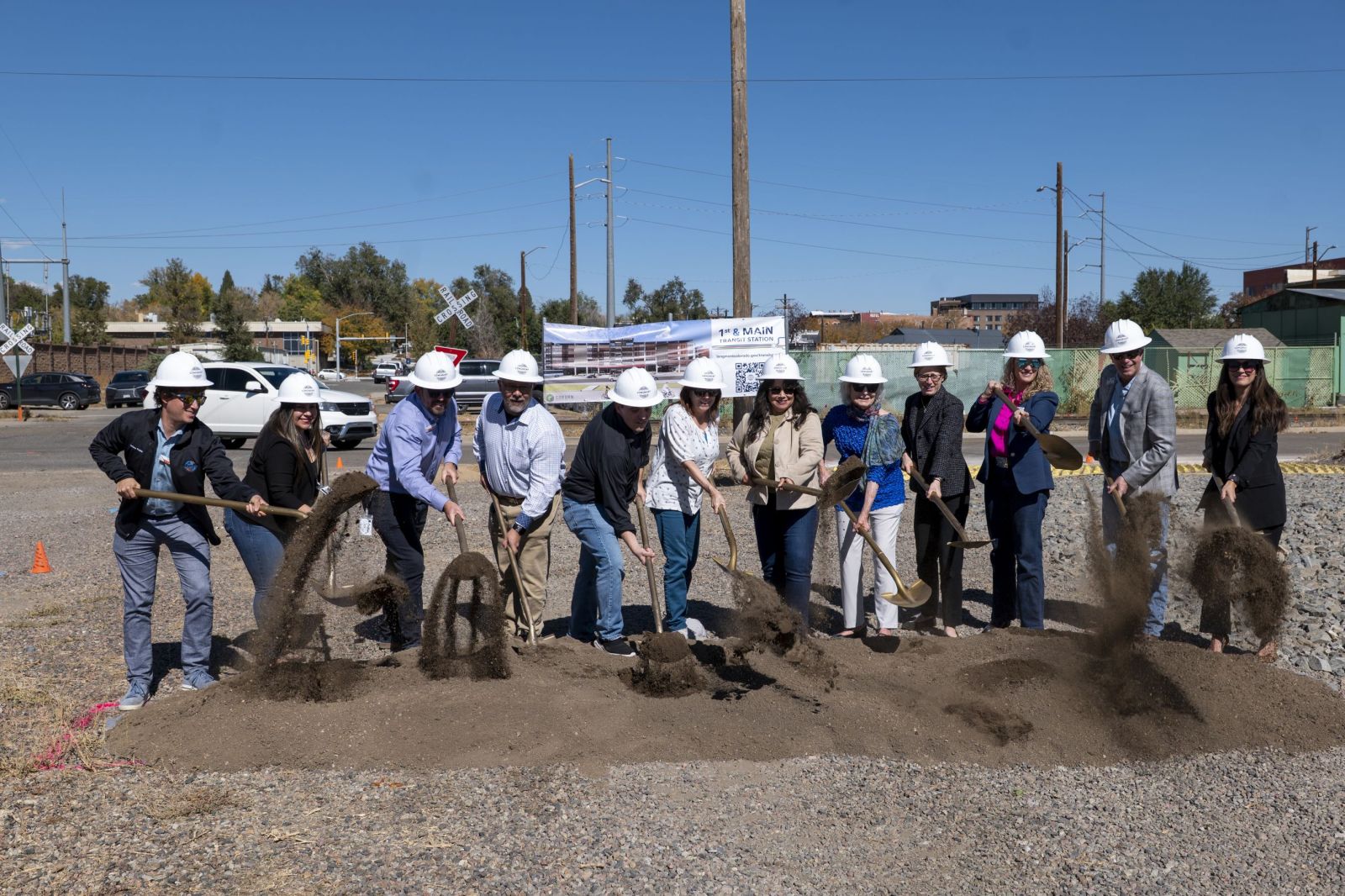 People scooping dirt with gold shovels, left to right: Matthew Popkin, Councilmember, City of Longmont Crystal Prieto, Councilmember, City of Longmont Alex Kalkhofer, Councilmember, City of Longmont Harold Dominguez, City Manager, City of Longmont Jake Marsing, Councilmember, City of Longmont Diane Crist, Councilmember, City of Longmont Susie Hidalgo-Fahring, Mayor, City of Longmont Joan Peck, Former Mayor, City of Longmont Shoshana Lew, Director, Colorado Department of Transportation Maria De Cambra, Executive Director, Colorado Department of Local Affairs Patrick O'Keefe, Board Chair, Regional Transportation District Lisa Kaufmann, Senior Strategic Advisor, Office of Governor Jared Polis