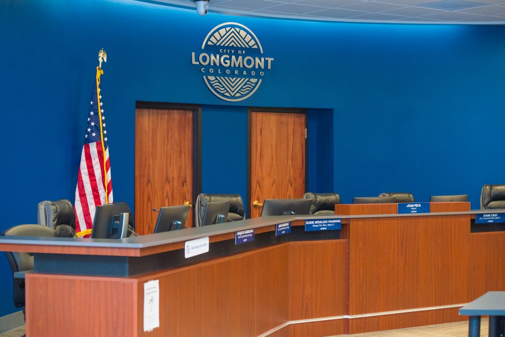 Longmont city council chambers dias with American Flag