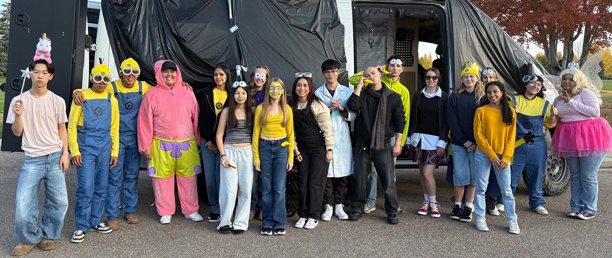 Youth Council Members and Children, Youth and Families staff pose in costume at at Family Festival Trunck or Treat event.