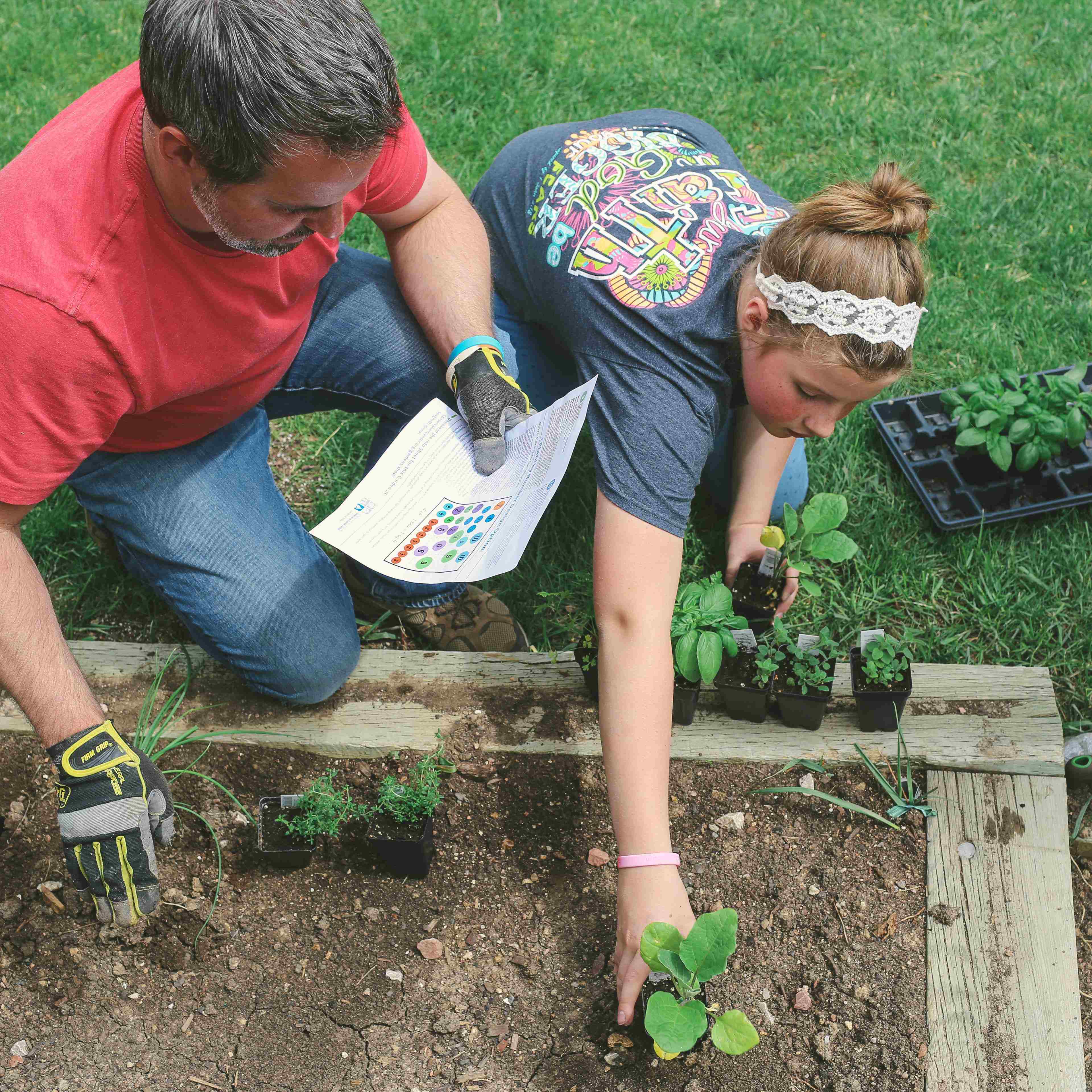Two people planting vegetables