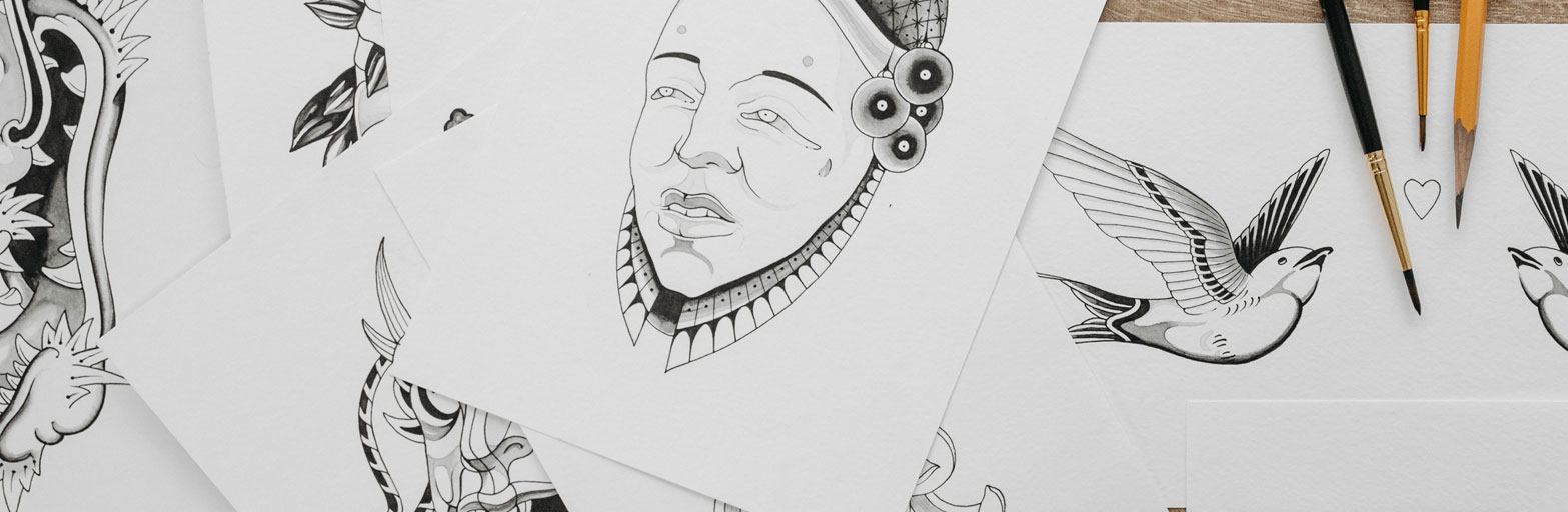 photos of white pages covered with pencil drawings of faces and creatures.